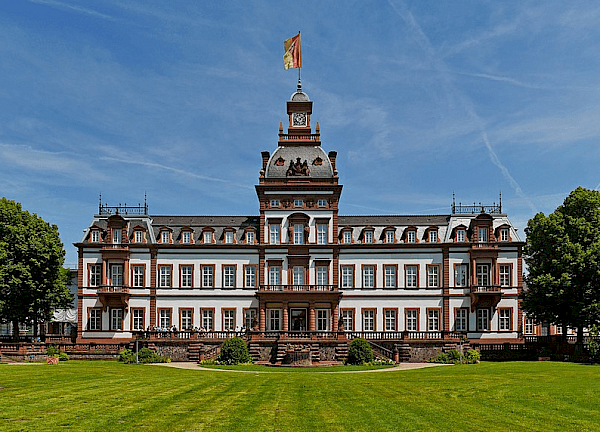 Frontansicht von dem Schloss Philippsruhe in Hanau mit der kunstvollen Fassade und blauem Himmel im Hintergrund